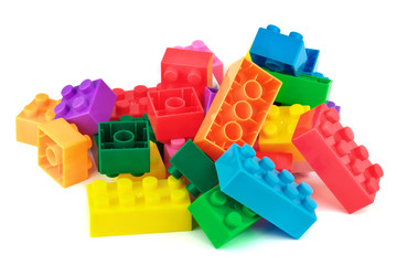 Fototapeta premium Toy colorful plastic blocks on white background
