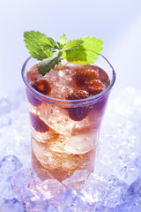 cold refreshment with raspberries, mint and soda on ice cubes.