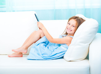 little girl holding a e-book