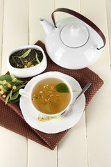 Cup of tea with linden on napkin on   wooden table