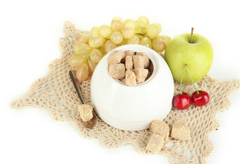 Unrefined sugar in white sugar bowl on grey background