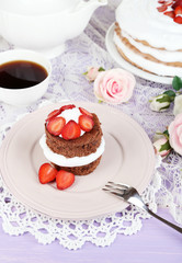 Chocolate cake with strawberry on wooden table close-up