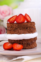 Chocolate cake with strawberry on table close-up