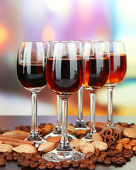 Glasses of liquors with almonds and coffee grains,