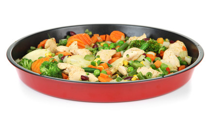 Casserole with vegetables and meat on pan, isolated on white