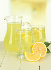 Delicious lemonade on table on light background
