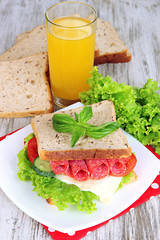 Composition with fruit juice and tasty sandwich with salami