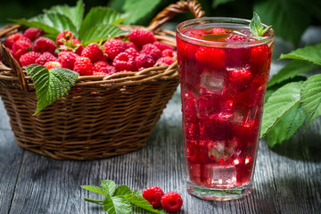 Juice of fresh raspberries served with ice in a glass