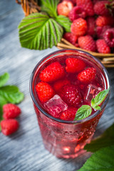 Closeup of juice with fresh raspberries and ice