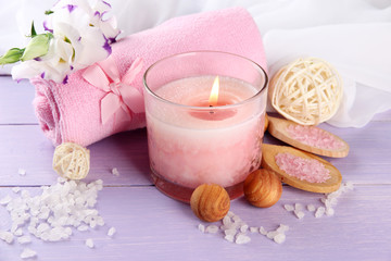 Fototapeta na wymiar Beautiful spa setting with pink candle and flowers