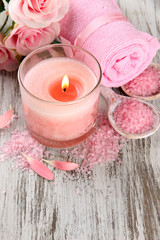 Fototapeta na wymiar Beautiful spa setting with pink candle and flowers