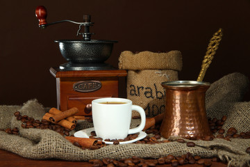 Metal turk and coffee cup on dark background
