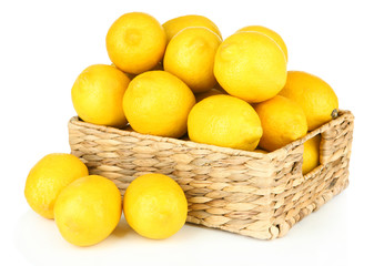 Ripe lemons in wicker basket isolated on white