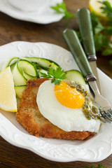 Wiener schnitzel with fried egg and capers.