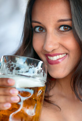 Close-up of young woman with a glass of beer