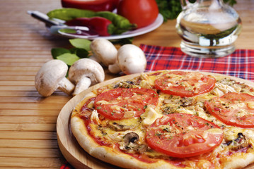 Pizza with mushrooms and tomatos