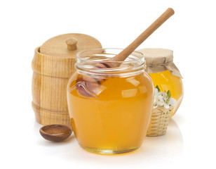glass jar full of honey and stick