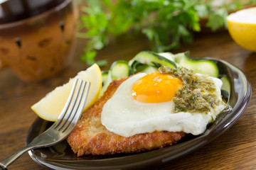 Wiener schnitzel with fried egg and capers.