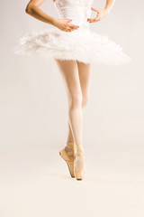 Beauty legs of ballerina on white