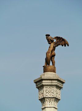 An angel opposite a blue sky in Vicenza in Italy