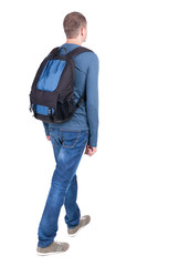 Fototapeta premium back view of walking man with backpack.