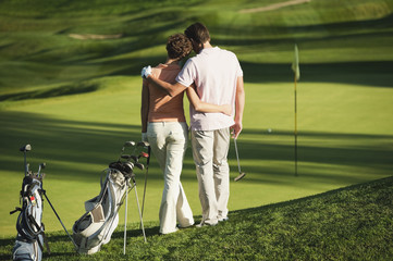 Italy, Kastelruth, couple standing on golf course