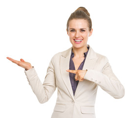 Happy business woman pointing on empty palm