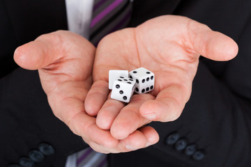 Business man holding dice