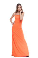 Beauty in dress. Beautiful young woman in orange dress posing wh