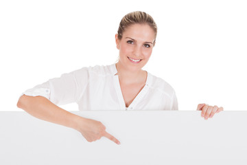 Young woman presenting blank placard