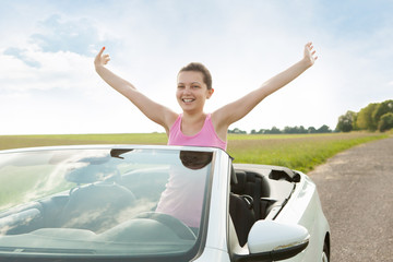 Woman Raising Hand In Car