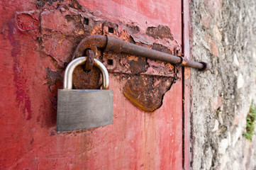 old metal door with padlock in grungy style