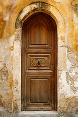Fototapeta na wymiar Old wooden door in city of Rethymno, Crete, Greece