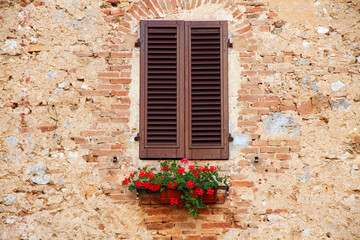 Fototapeta na wymiar Window on the Facade of Italian stone wall