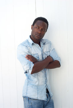 American Man Leaning Against Wall With Arms Crossed