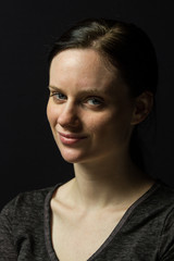 Young woman smiling at camera, vertical
