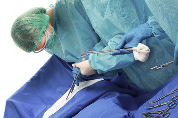 Below view of surgeons holding medical instruments in hands