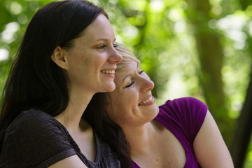 Girlfriends enjoying day in park, horizontal
