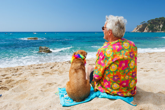 Senior man with dog on beach