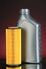 Car oil filter and motor oil can on dark color background