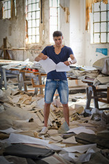 Attractive young man in messy office or working place