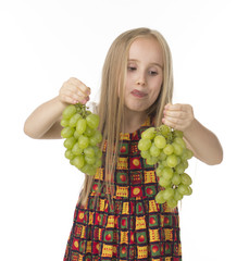 girl in a beautiful dress with grapes