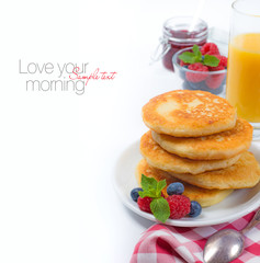 Breakfast with cottage cheese pancakes, berries, jam and juice