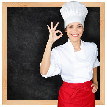 Chef showing menu blackboard and Perfect hand sign