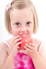 Portrait of happy child eating red apple