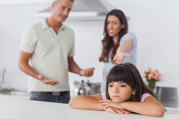 Couple having dispute in front of their upset daughter