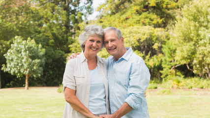 Fototapeta premium Happy mature couple smiling and looking at camera