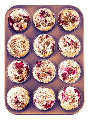 Homemade chocolate and cherry muffins in paper cupcake holder in