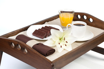 Orange juice, cookies and cup of coffee over wooden tray