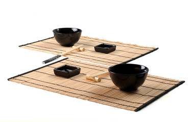 asian table setting on a bamboo mat